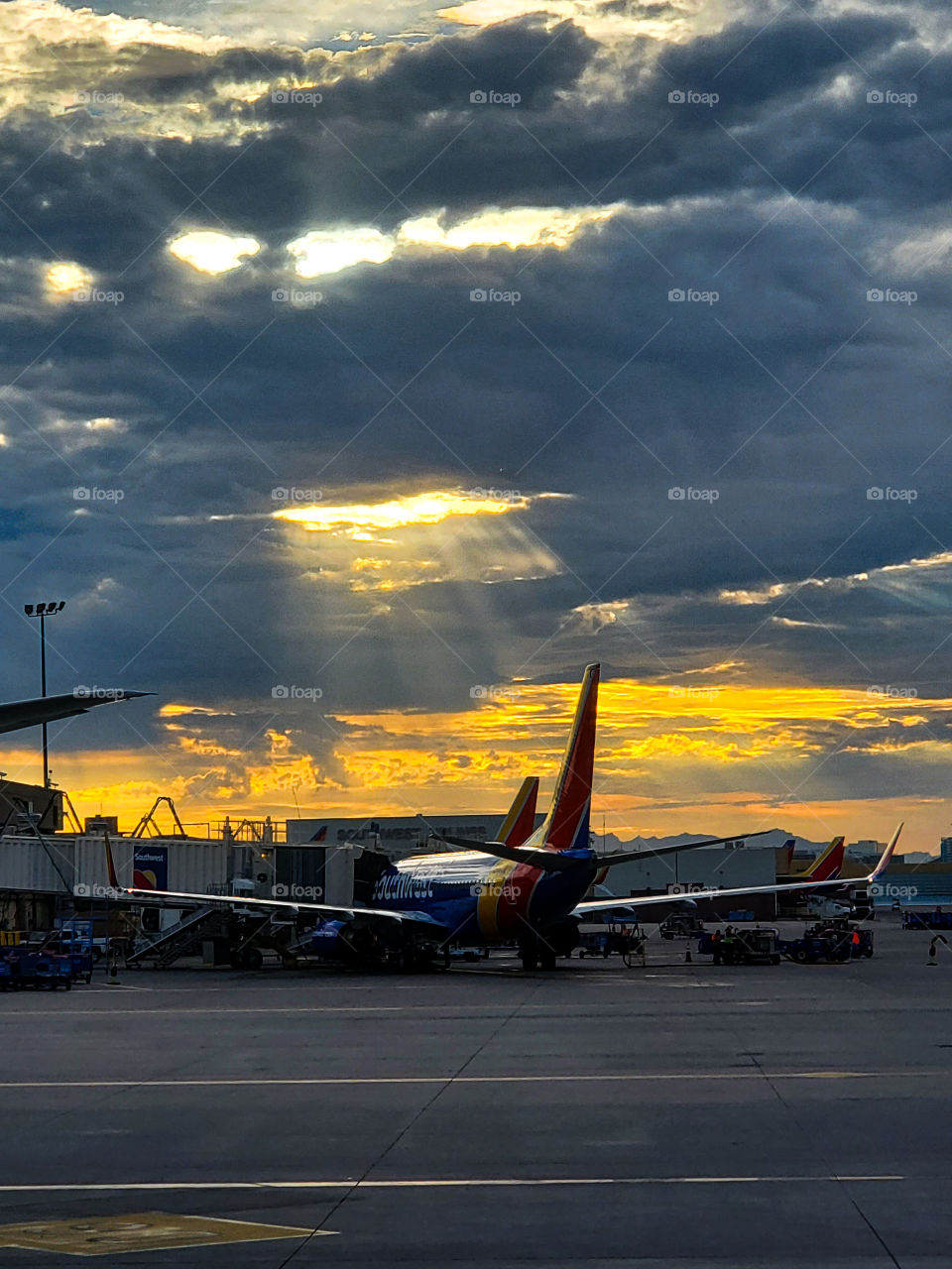 Virga and sunlight shafts create a beautiful background over the Phoenix Sky Harbor Airport in Arizona