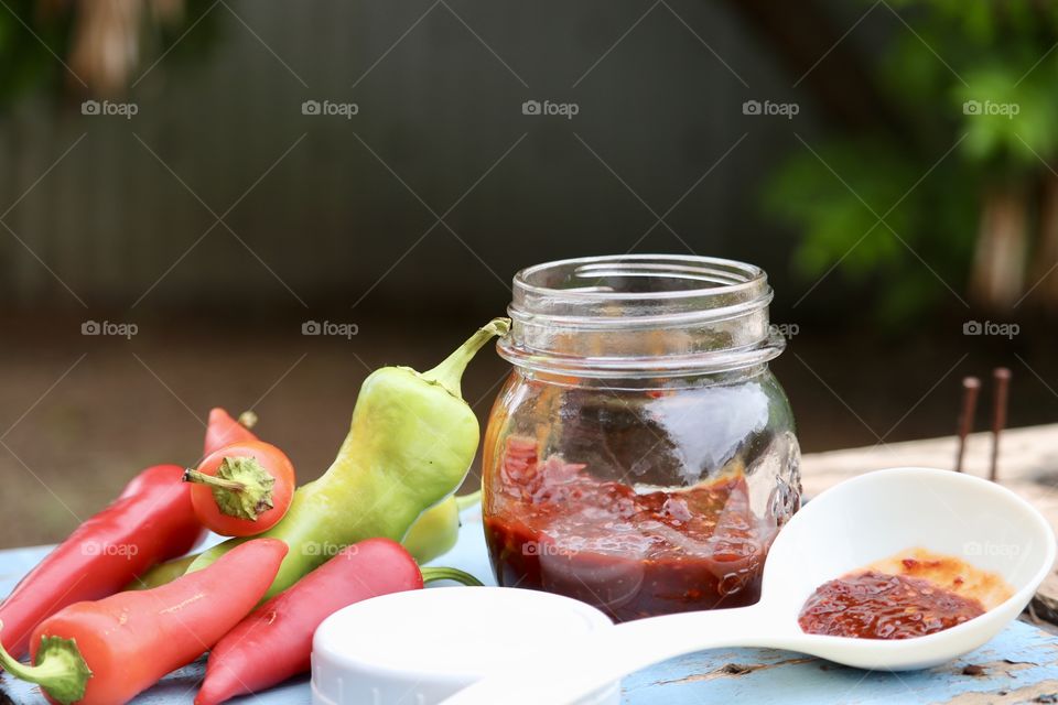 Rustic outdoor shot Bokeh blurred background pint canning jar red pepper preserves 