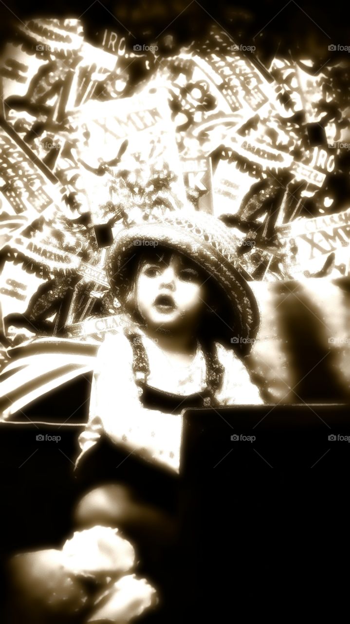 Close-up of a girl against comic books