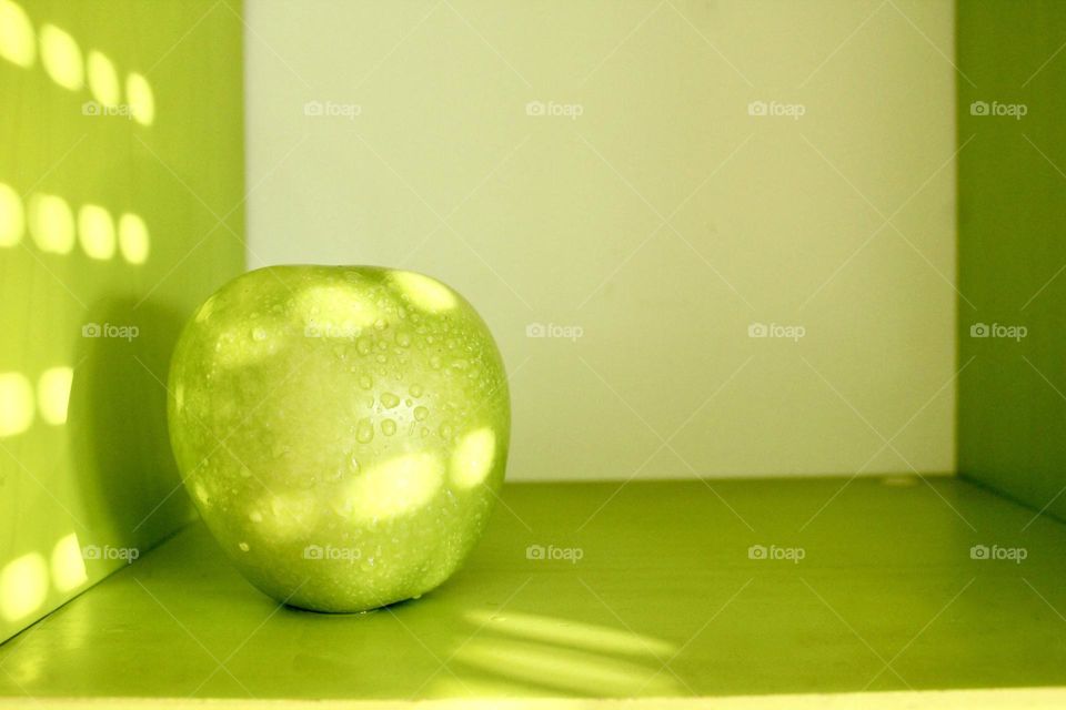 Green Apple on green background 