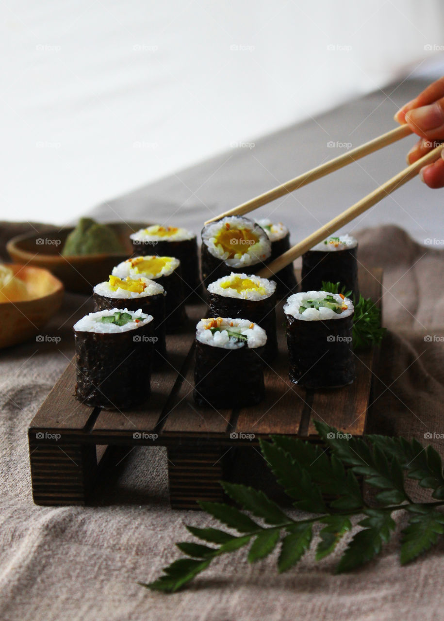 assorted sushi on wooden board