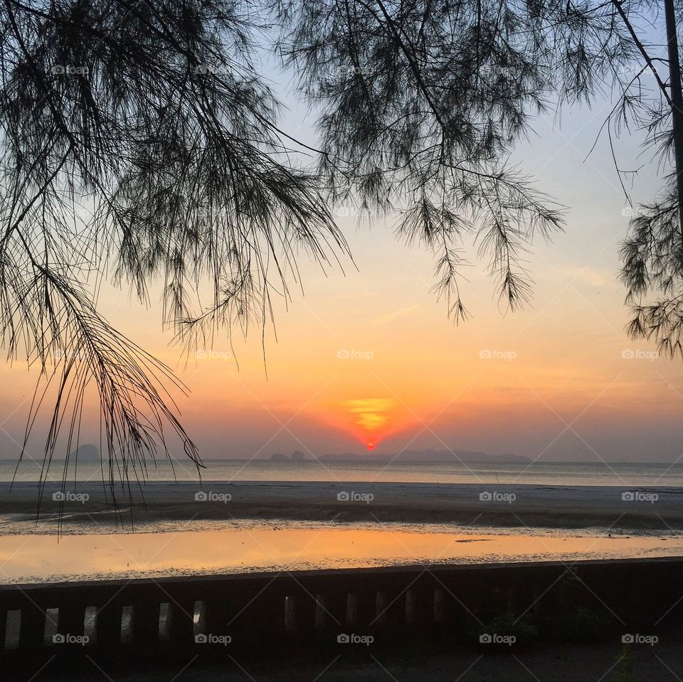 Scenic view of seashore against sunset sky
