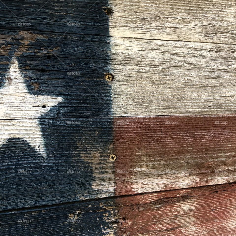 Painted Texas flag on wood. Left outside so it’s very weathered and the colors are still there!