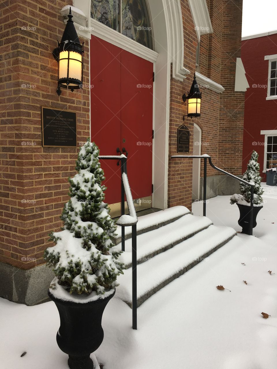 Freshly Fallen Snow On Church Doorstep and Evergreens