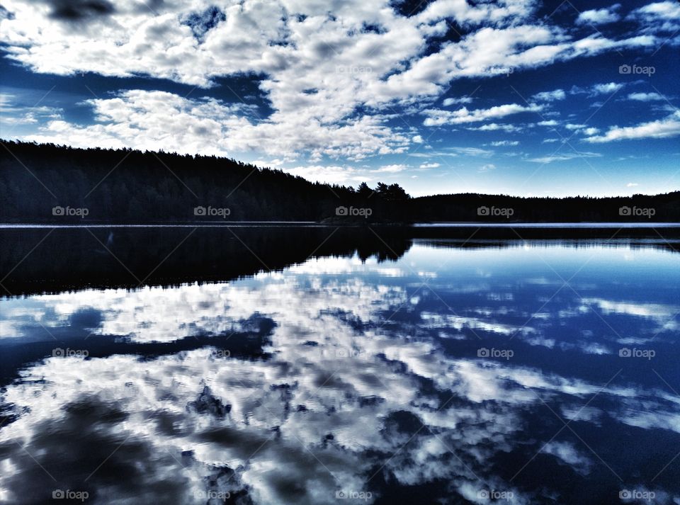 Forest lake in norway, beautiful sky reflection