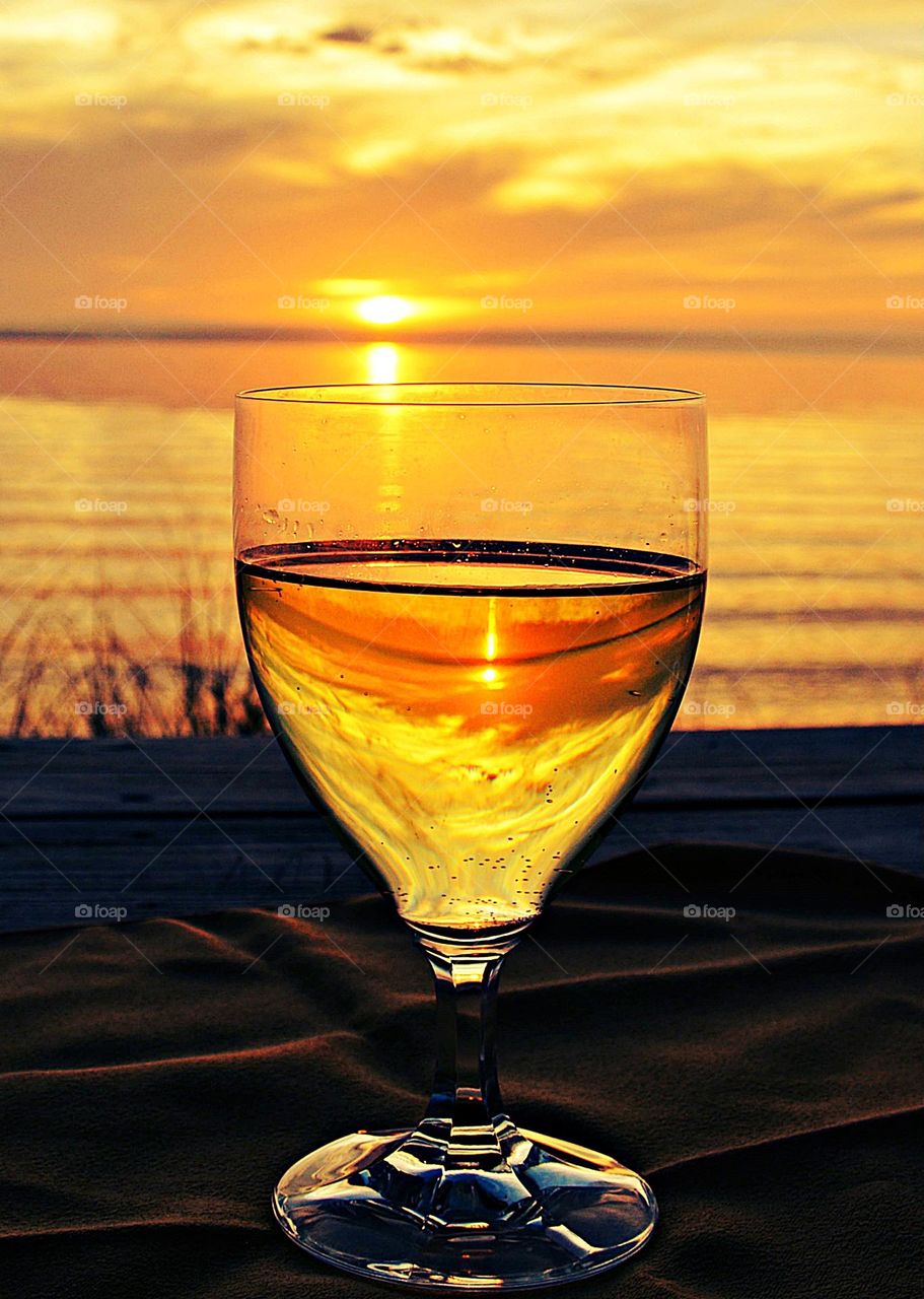 Enjoying a nice glass of wine at the end of the day, during the last light of the night,  as the magnificent sunset sinks below the horizon