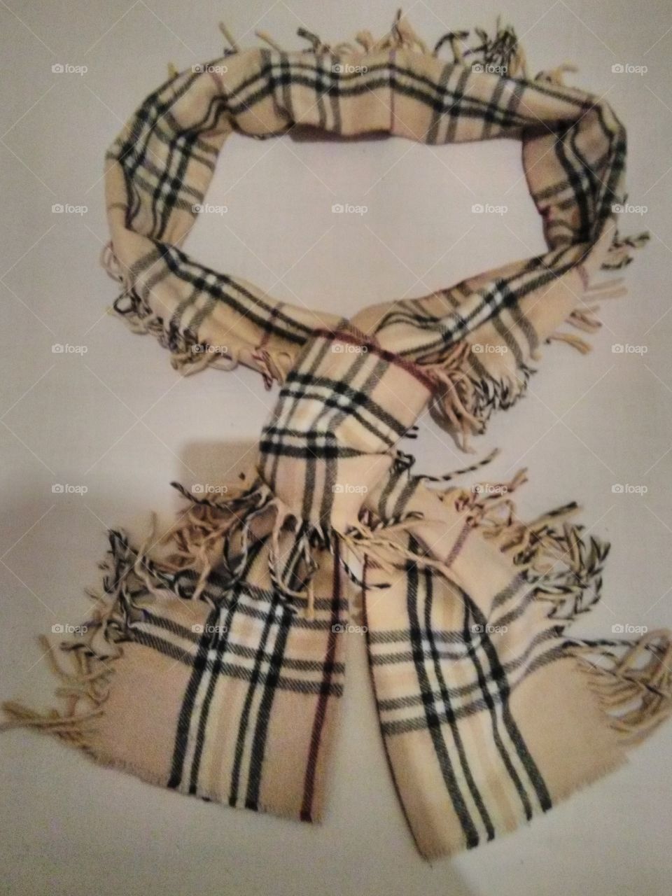 This photo shows a stylish Burberry scarf which is both feminine and masculine. It can be worn with both casual or official attires.