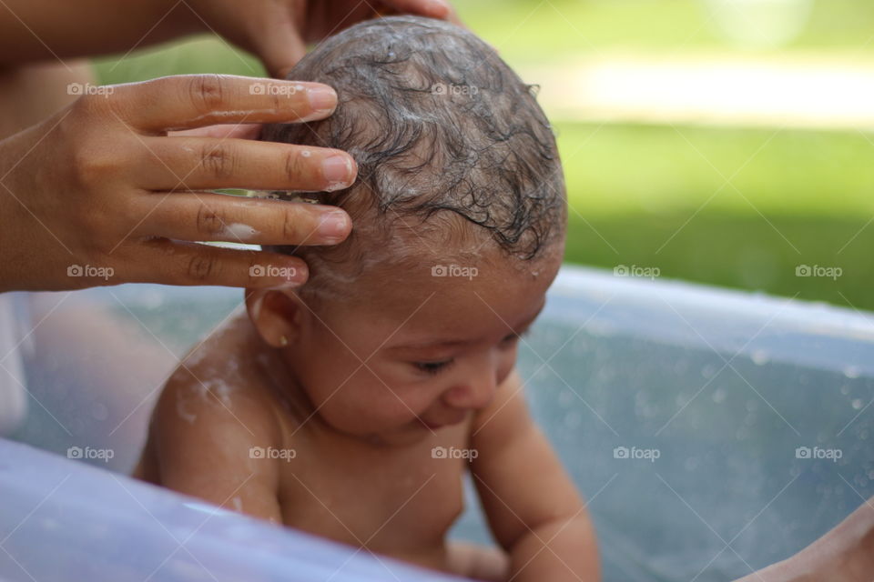 baby bathing in the garden