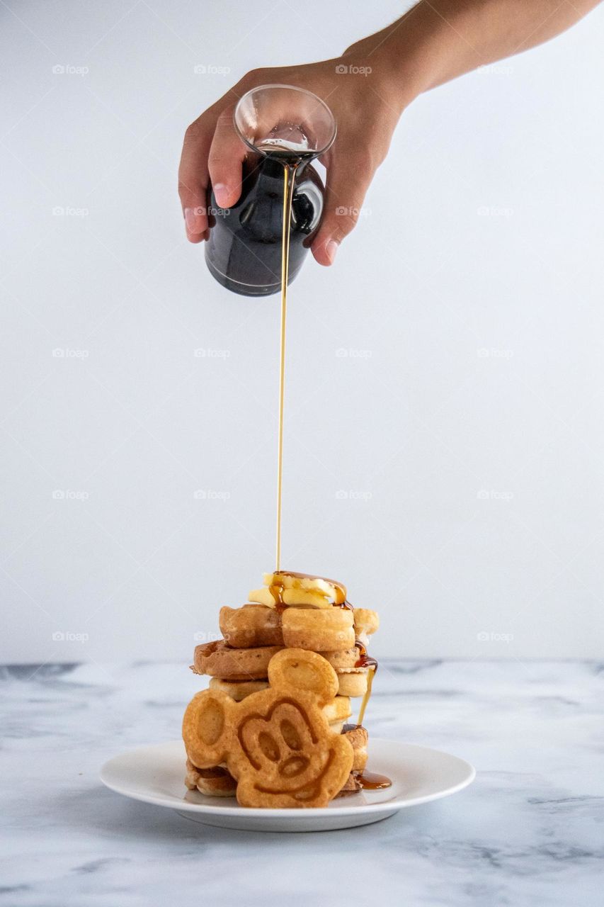 Pouring Syrup on Waffles