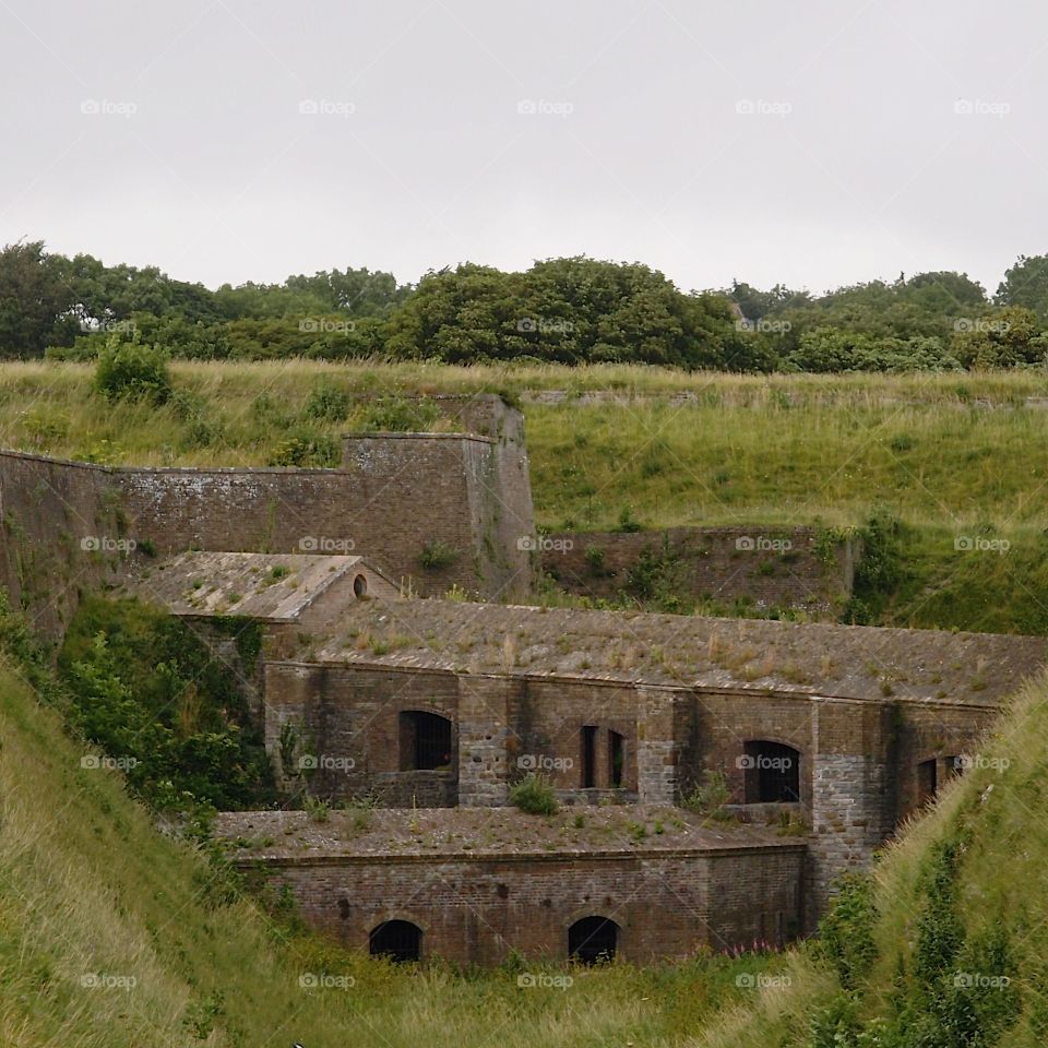 Part of the Dover Castle on a hill in England on a summer day. 