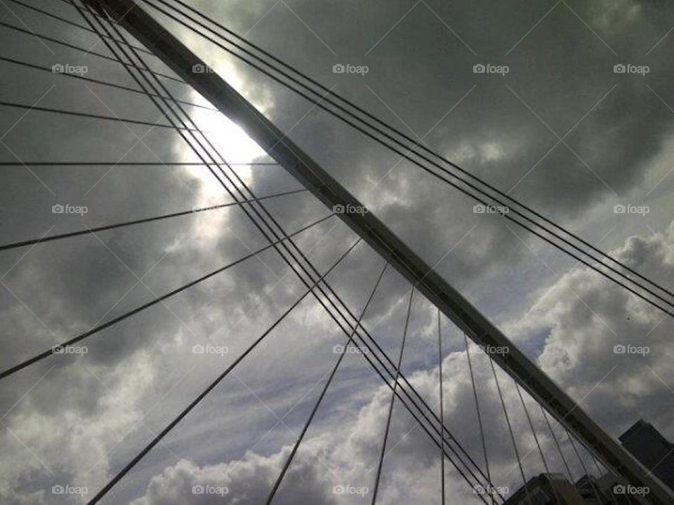 Monochromatic view of the sky through a bridge 