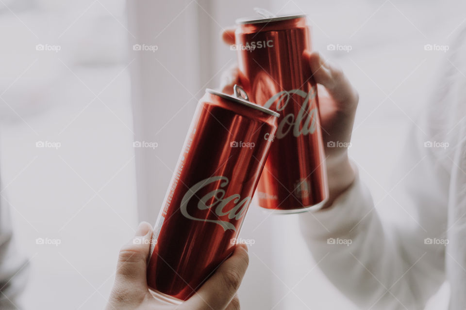 coca cola in hands / cheers with coca cola