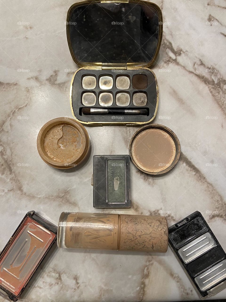 A “sad face” made of my collection of empty and almost- empty makeup containers. On the plus side, I use what I buy. On the minus side, I sometimes run out before I can afford to buy more but that just makes it sweeter when I can. 