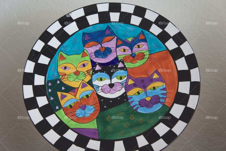 A beautiful colorful ceramic plate with six different facial cat  expressions,