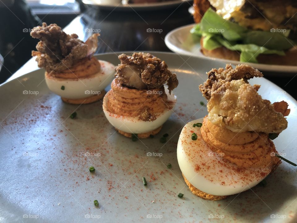 Deviled eggs with country ham and fried oyster