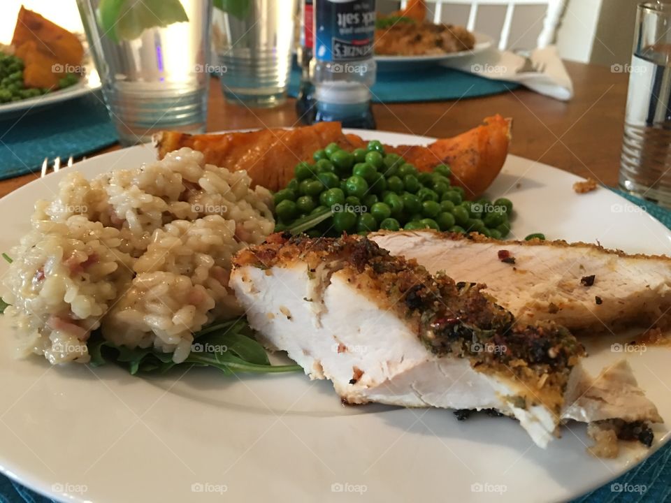 Mushroom risotto over arugula (rocket) and grilled chicken breast, with maple syrup glazed butternut squash pumpkin, and minted peas sides