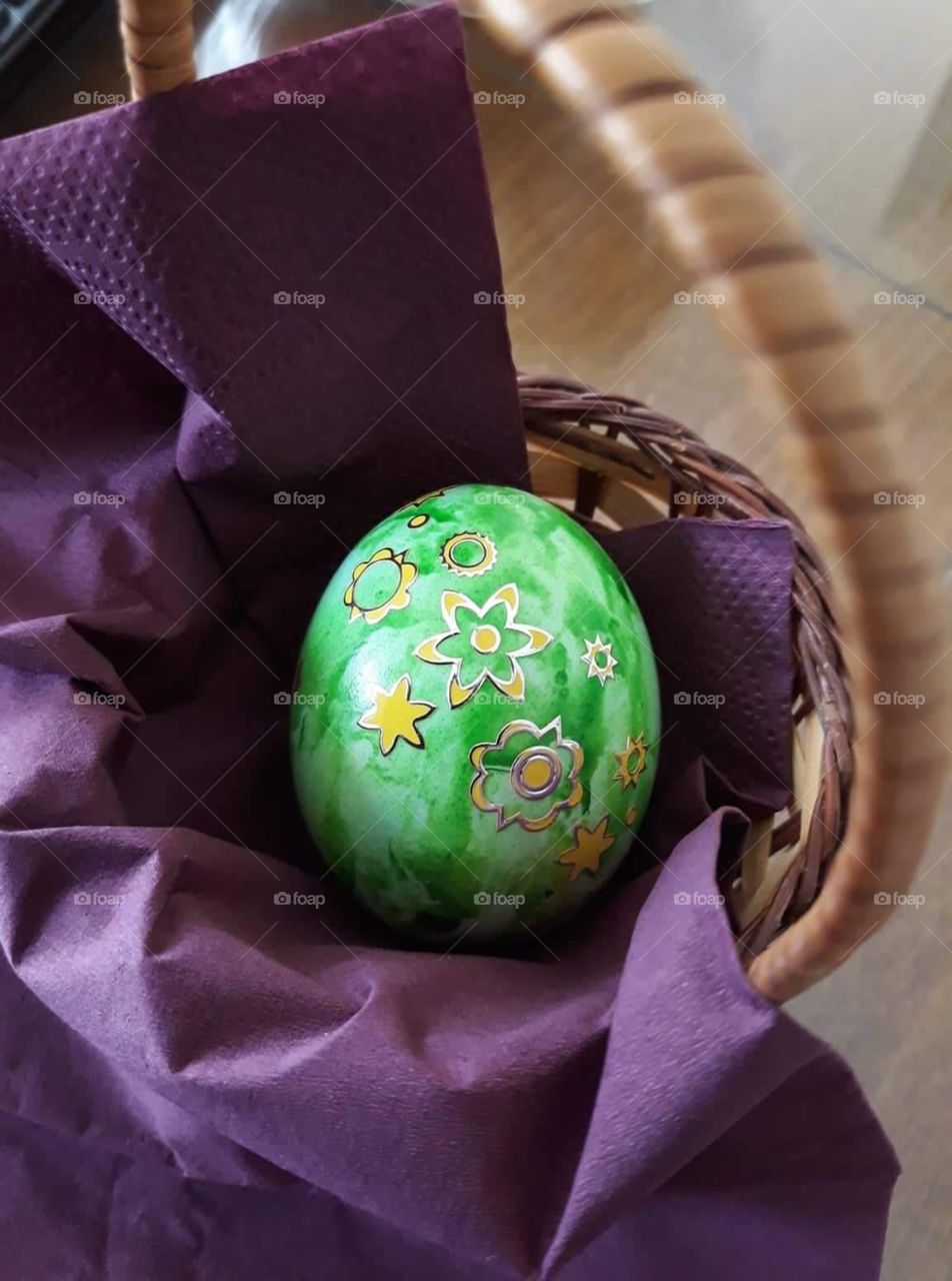 Green Easter egg with stickers.