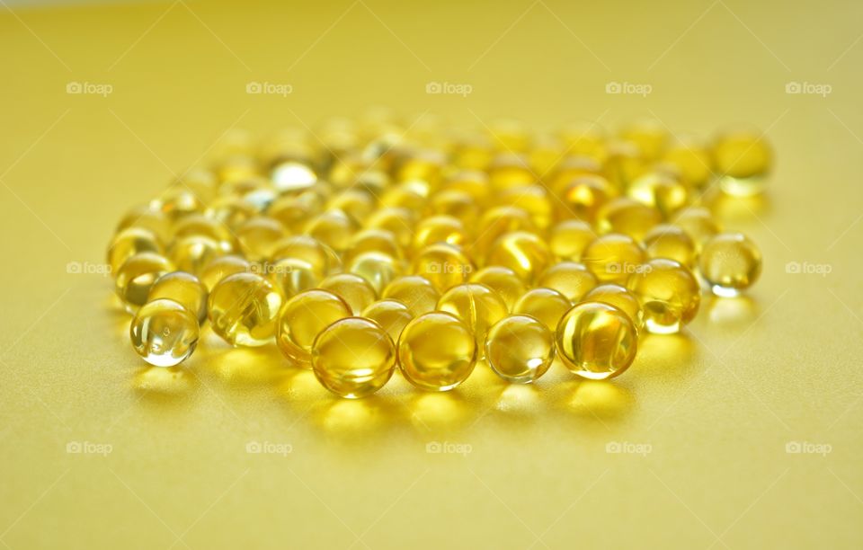 vitamins capsules round beautiful round texture yellow background