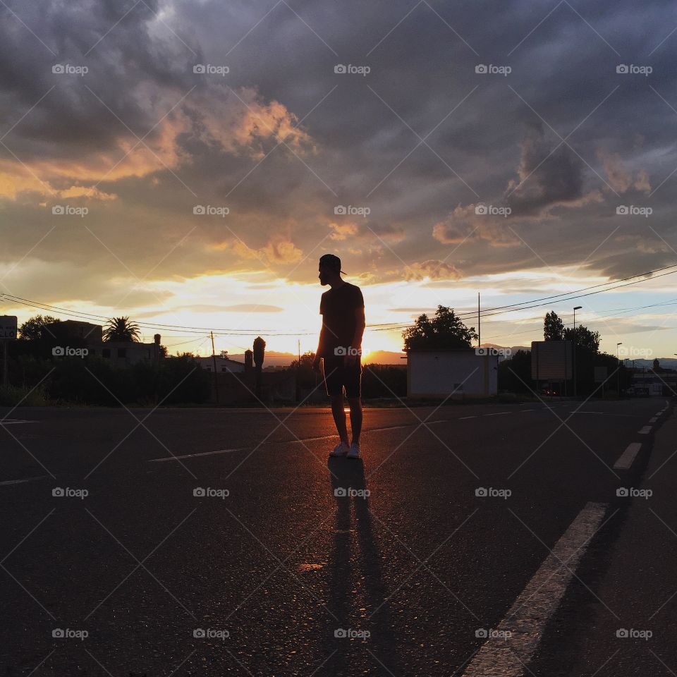 The Golden Hour. Man standing in front of the golden bulb