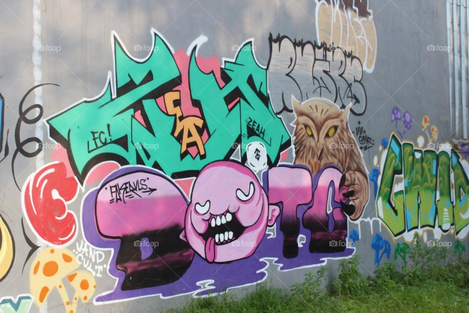 Gravity is the work of street children by spilling spray paint on a wall even though it looks random but it has meaning for them