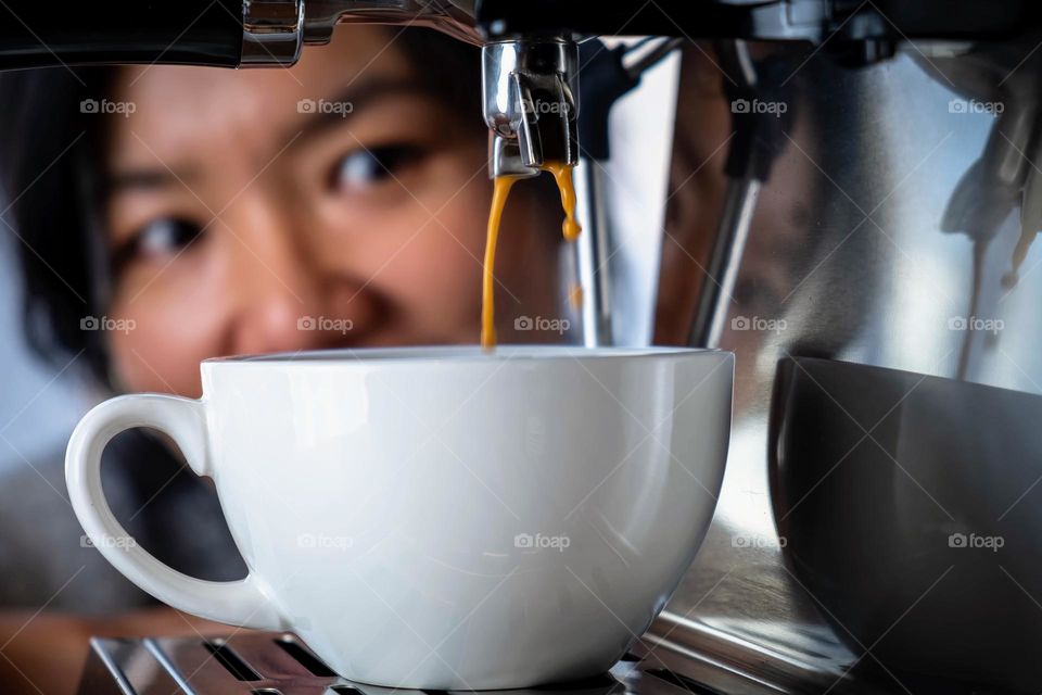 A young lady of Taiwanese decent is super excited about her espresso.