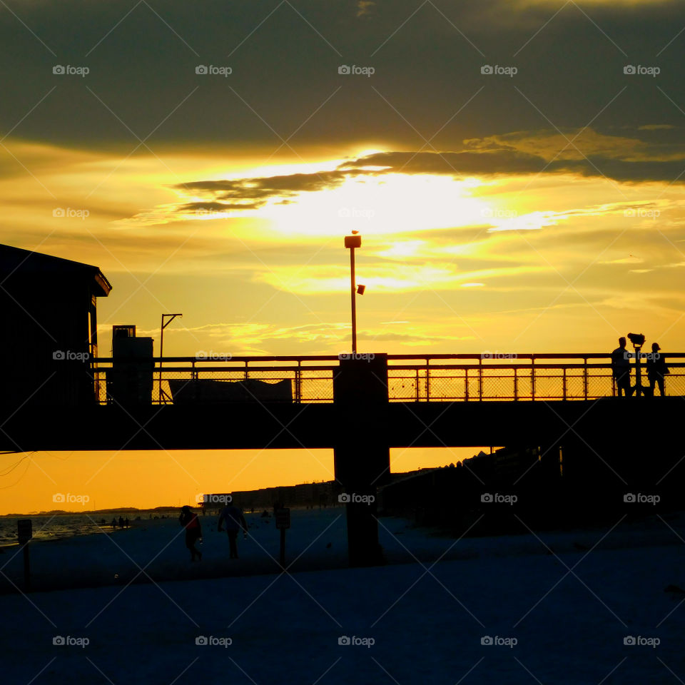 The sun  shone brilliantly and the water in the ocean glittered invitingly! A golden glow spread across the sky as the sun chased the dark clouds away! The sunset is free, so go outside and capture it!