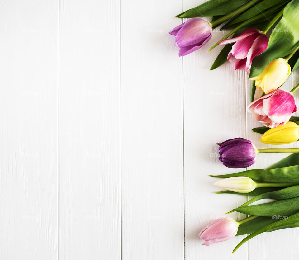 Spring tulips on a white table 