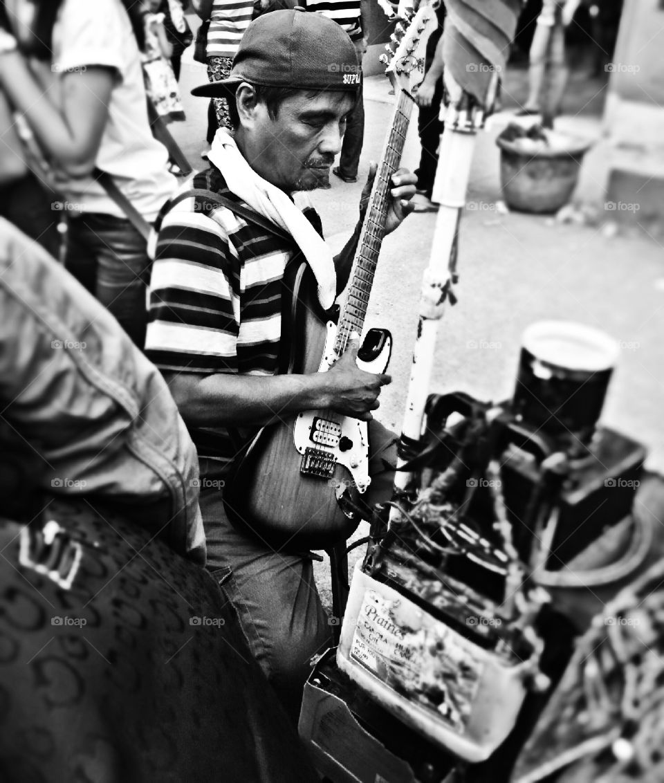 A blind musician . A blind musician singing ang playing guitar