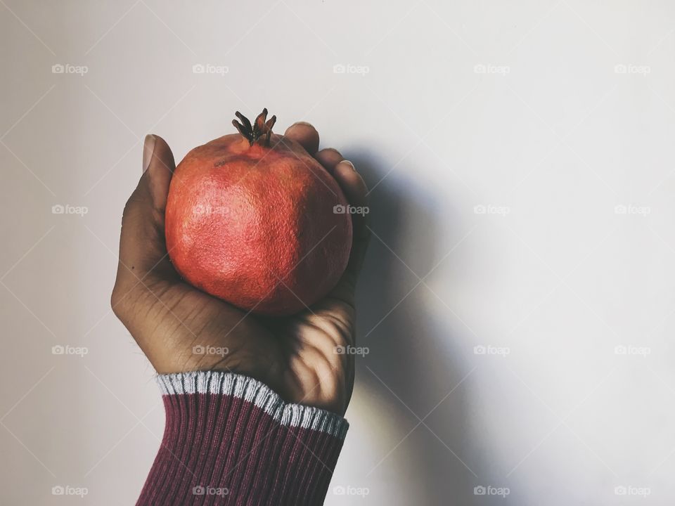 Holding pomegranate