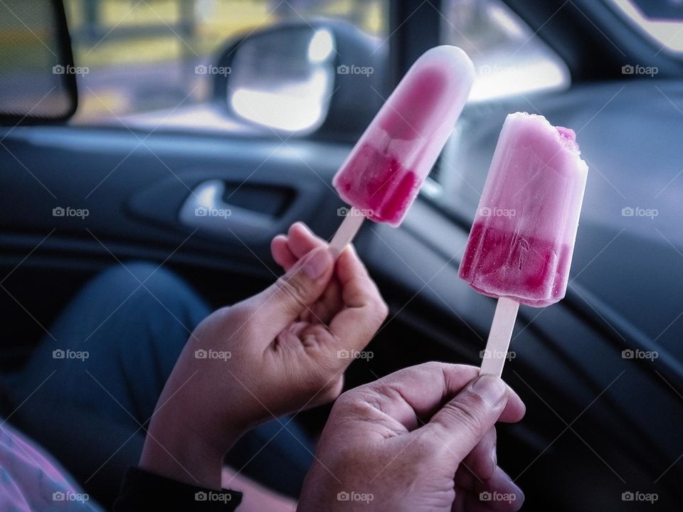 Enjoying strawberry icecream in the car