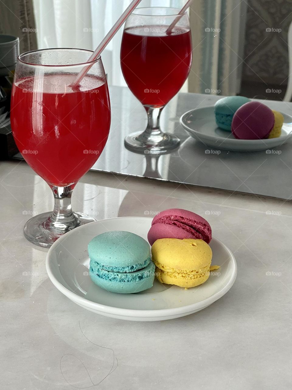 Colourful macarons and glass with cocktail 