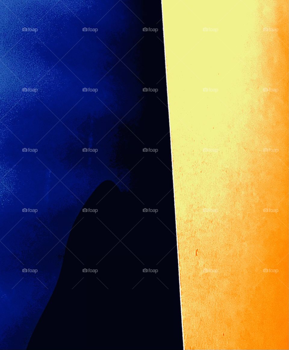 An abstract photograph of two opposite hues with their values. The blue represents coolness whereas the yellow symbolizes warmth.