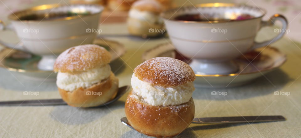 Tea time with pastry on spoons.