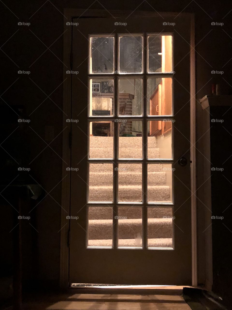 Doorway to a room casting lovely shadows of light through the glass of the door