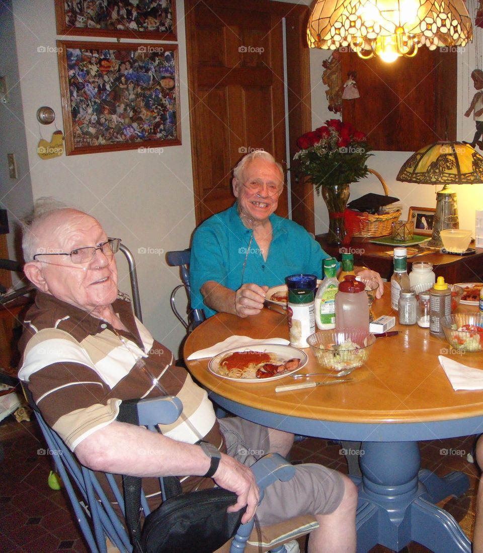 Friends using Oxygen, enjoying dinner together smiling.