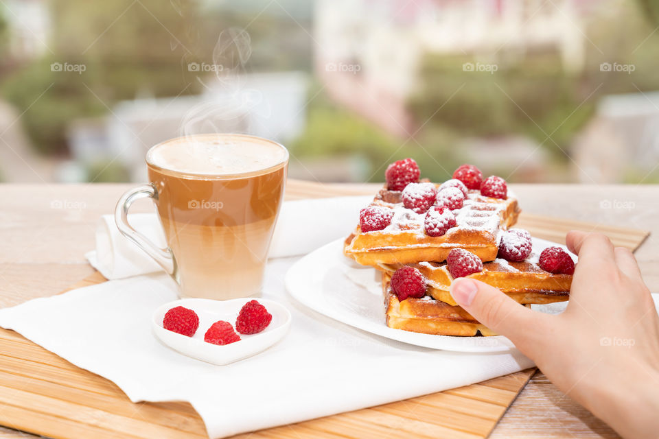 coffee with milk and Belgian waffles for breakfast