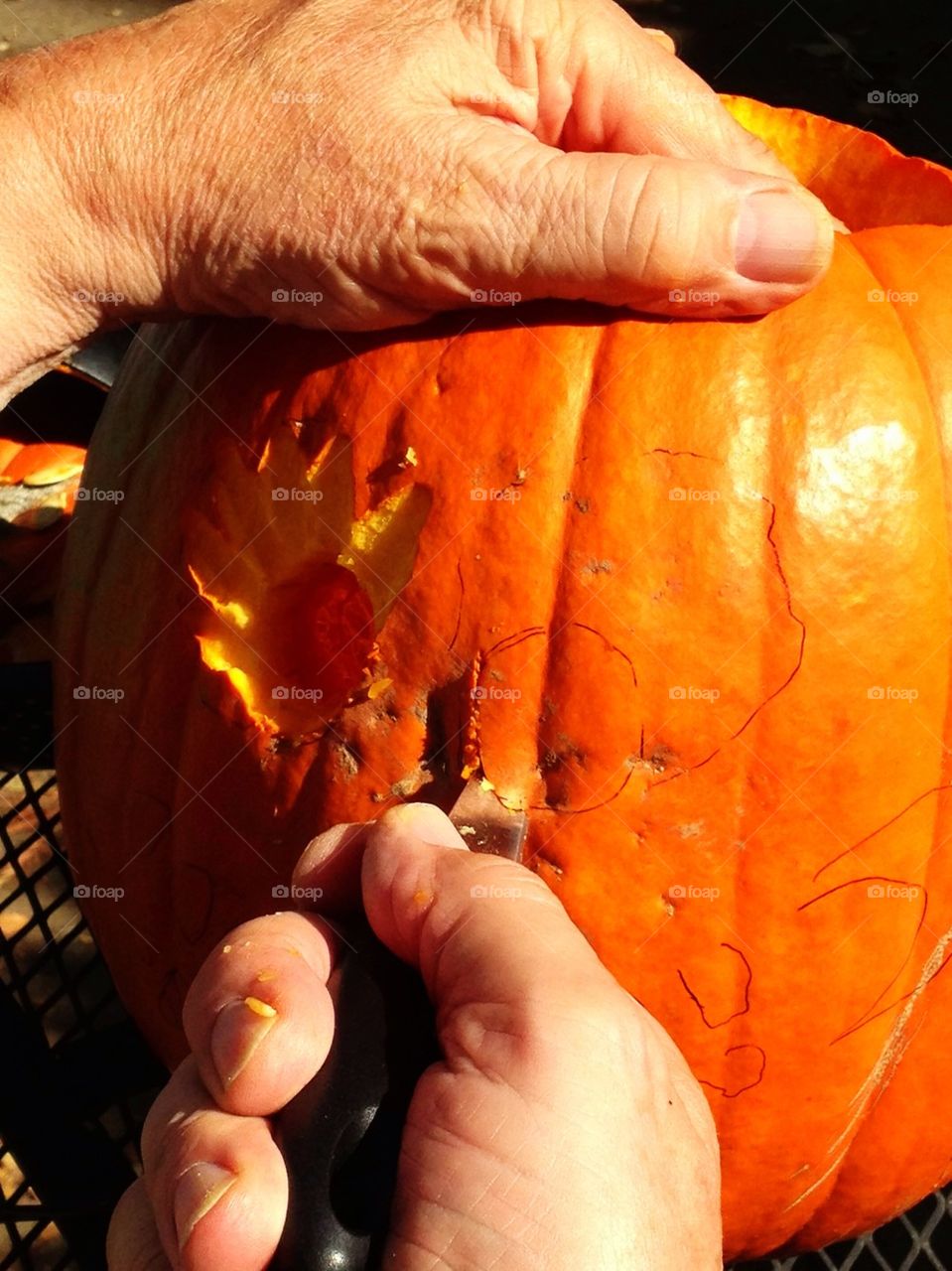 Man carving pumpkin