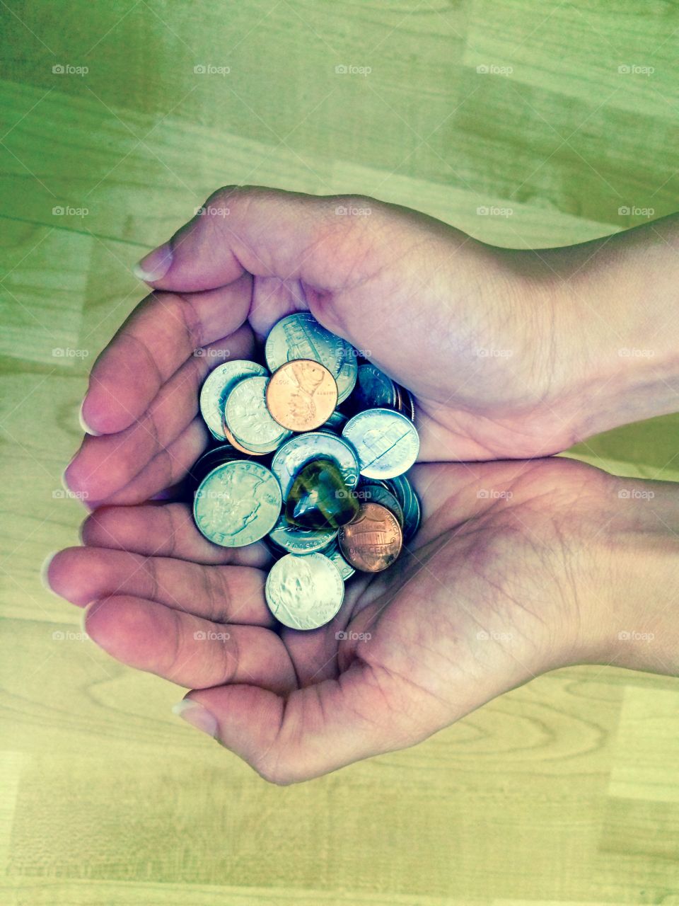 Human hand holding coins