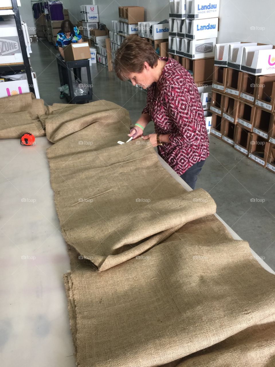 Woman cutting sack in the industry