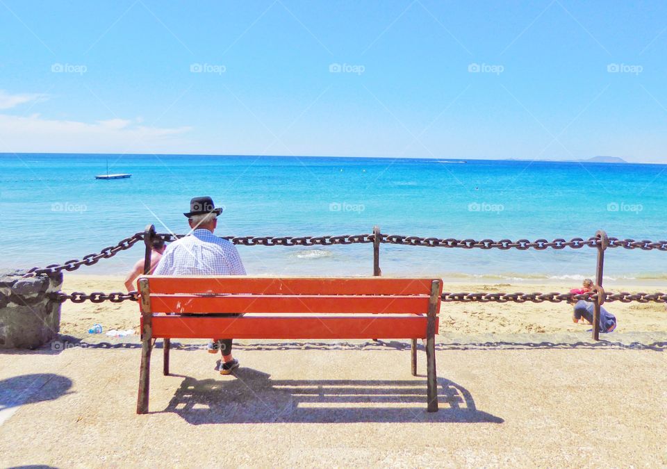 Man sitting on bench looking at view
