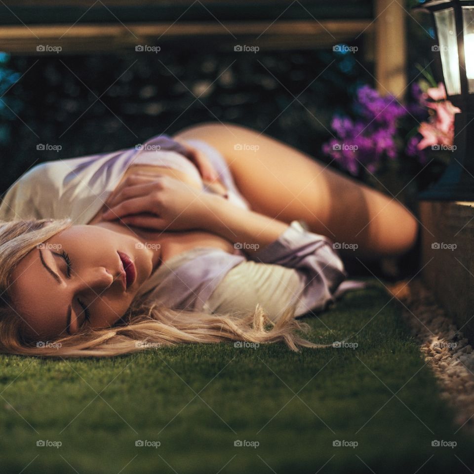 Sexy woman lying in grass