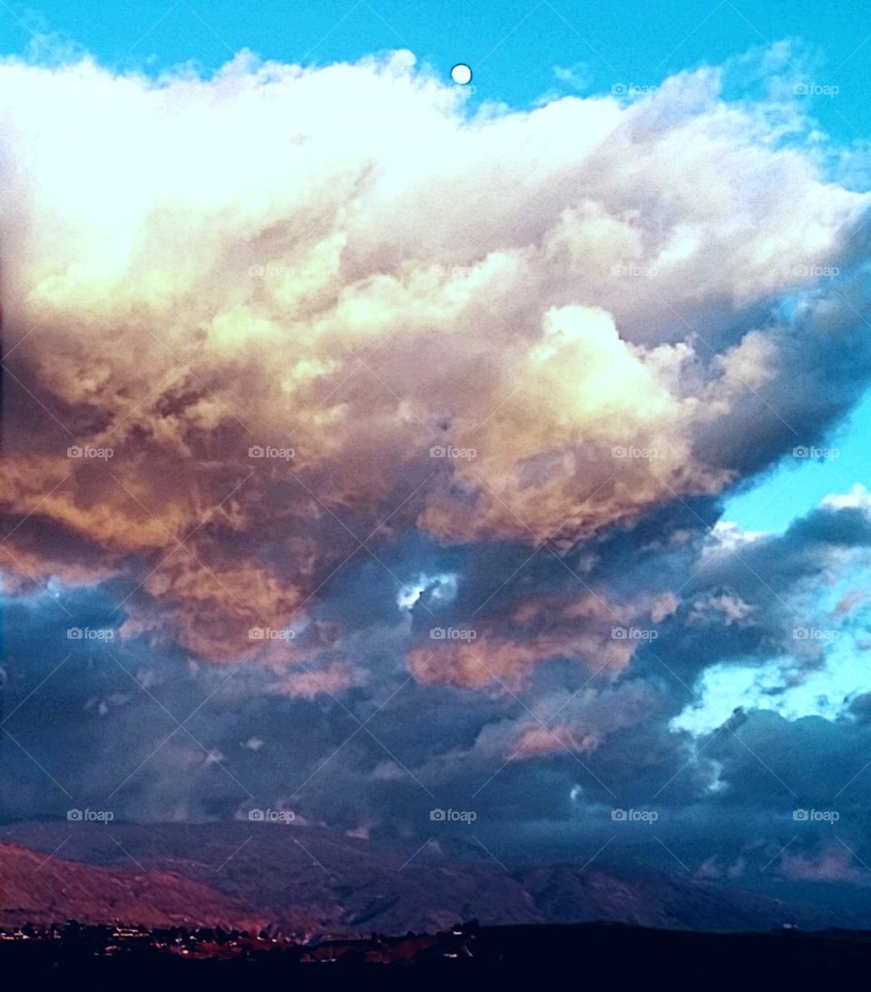 moon rising above the clouds