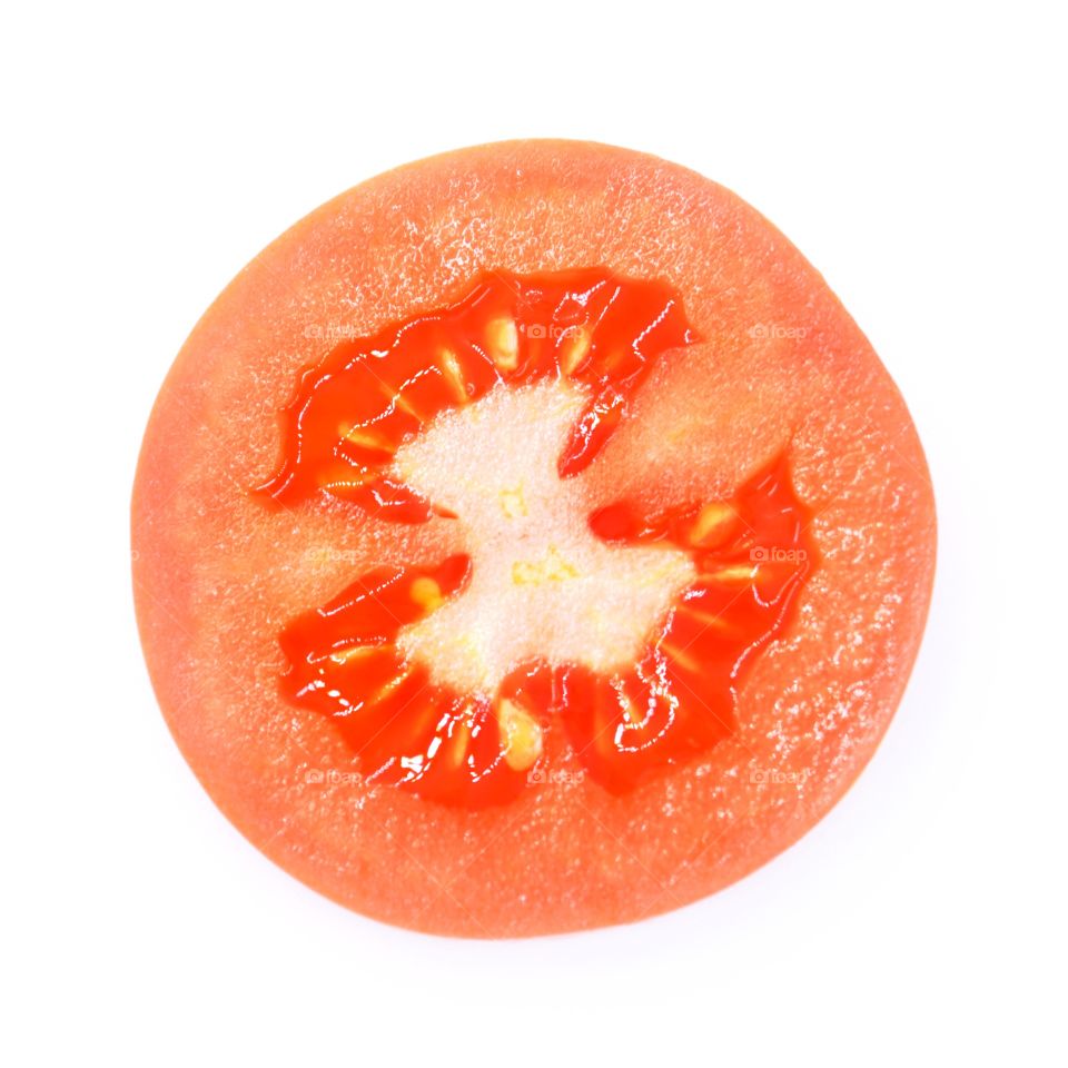 Slice of tomato on a white background