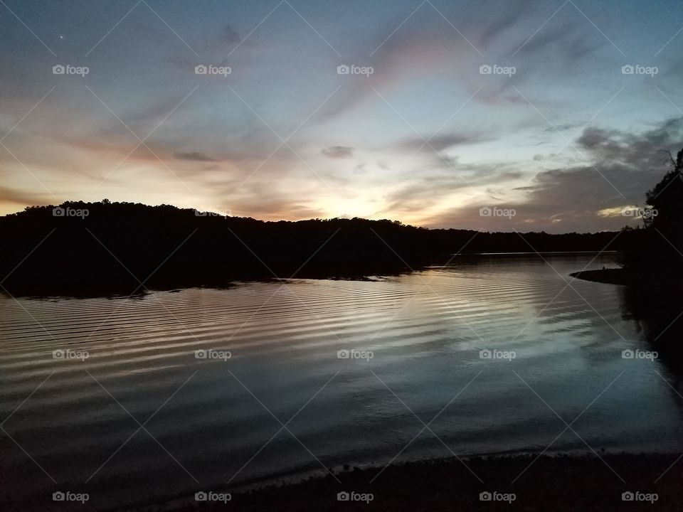 Dusk on the lake, reflections after a board wake