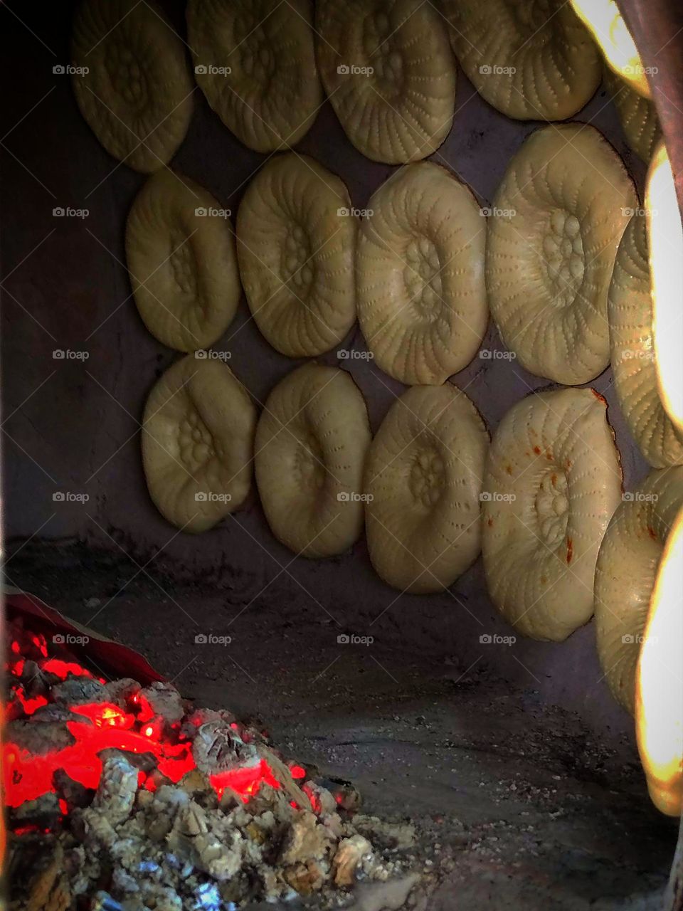 Food.  Tandoor is a place where lavash is baked.  Dough is attached to the walls, which is baked with hot coals.