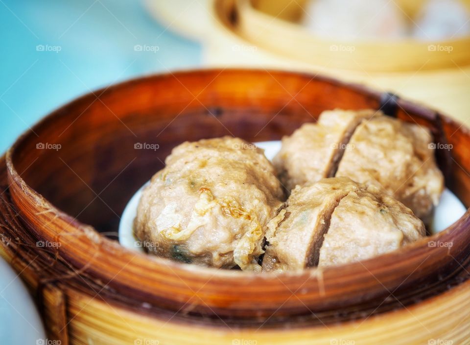 Beef and tendon balls. A popular yum cha or dim sum dish that is usually presented and kept warm inside a bamboo steamer.
