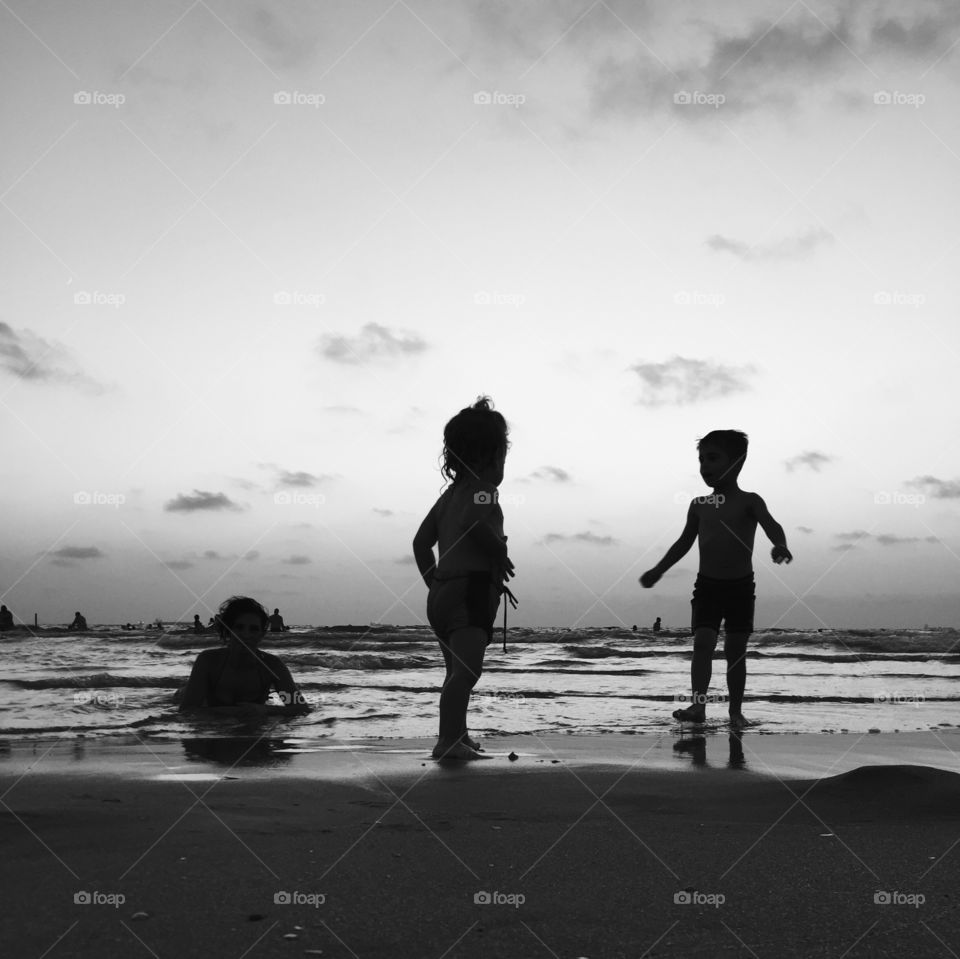 Silhouette of children at beach