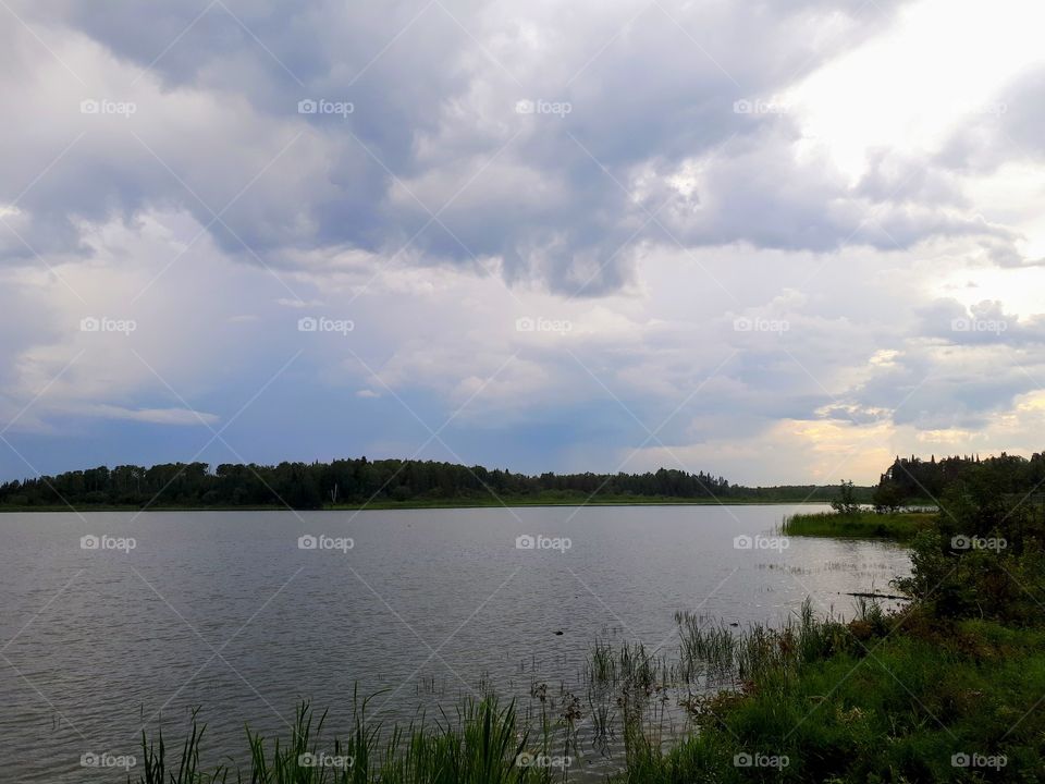 rain clouds and light over a Canadian lake
