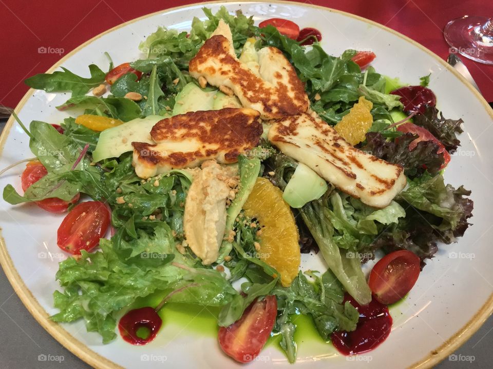 Delicious vegetarian salat with fried cheese and oranges