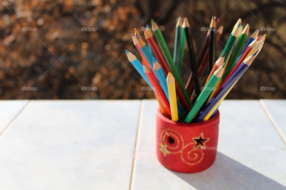 coloured crayons in a Christmas holidays decoration holder